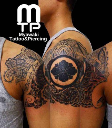 肩から二の腕にかけて、ヘナ模様のデザインと家紋。