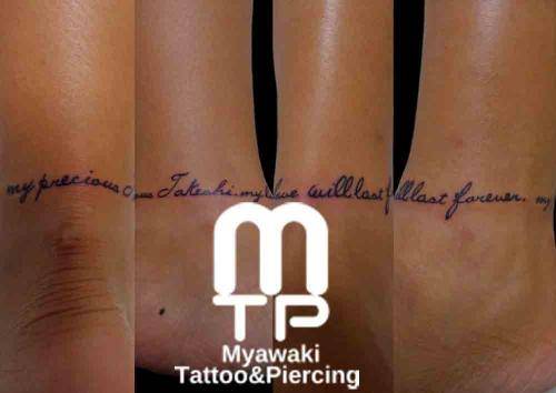 足首に筆記体で英文。